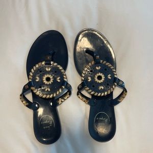 Jack rogers sandals. Hard plastic. Can wash with water or wipes.